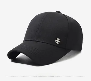 Dettaglio del cappellino sportivo nero con emblema metallico laterale su tessuto in twill