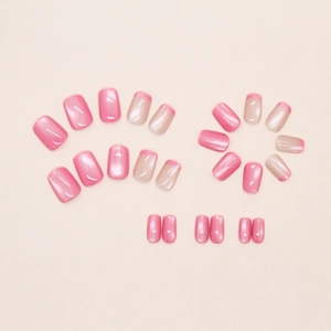 Close-up of pink cat-eye press-on nails and nude french tip style in short square shape