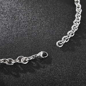 Close-up of silver titanium steel O-chain necklace with spring clasp and lobster hook