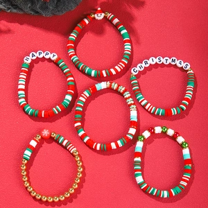 Detailed view of Christmas clay bead bracelet set with snowflake and Santa charms