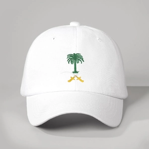 White cotton baseball cap featuring embroidered Saudi emblem with palm tree and swords