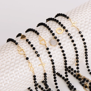 Set of 6 minimalist black beaded bracelets with gold infinity and heart charms