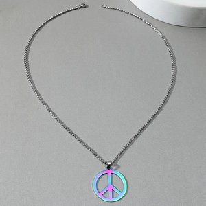 Detailed shot of an iridescent peace sign pendant with a silver ball chain necklace