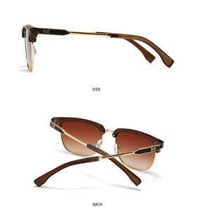 Detail view of tortoiseshell semi-rimless sunglasses with gold metal frame and side arrows