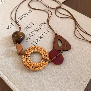 Bohemian retro resin pendant necklace with woven rattan circles on a book cover