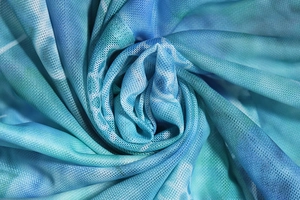 Detailed macro view of teal gradient mesh fabric with a breathable knit texture