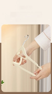 Flexible non-slip flocked hanger shown being bent to demonstrate high durability and resilience