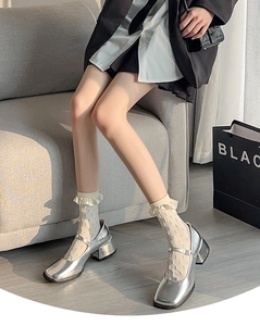 Detail of silver Mary Jane shoes with beige polka dot ruffle socks for Lolita style