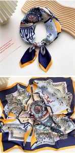Detail of silk-like square scarf with bohemian navy blue and orange geometric patterns