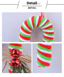Detail view of plush red and white striped candy cane with bell and pine needles