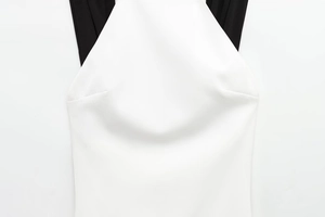 Detail of minimalist black and white patchwork dress showing knit fabric texture