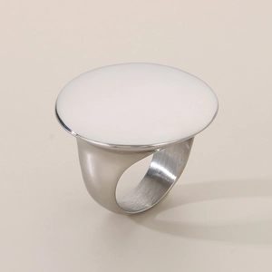 Detail view of silver stainless steel ring with white round flat disc inlay on top