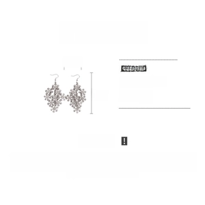 Detailed view of rhinestone snowflake drop earrings with size measurements and specs
