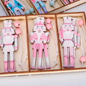 Pink and white wooden Nutcracker Christmas tree ornaments with decorative beads