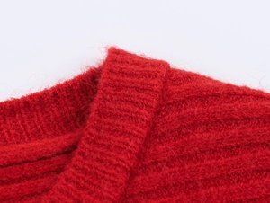 Close-up of bright red knitted sweater collar featuring soft textured mohair fibers