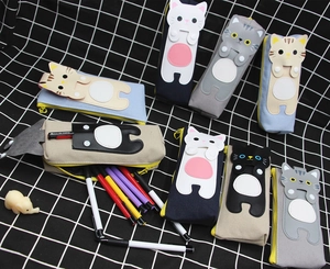 Detail of cute cat canvas pencil case showing cat ear patches and yellow zipper closure