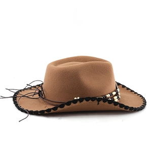 Detail of western brown felt hat with woven brim edges and ethnic bead decorations