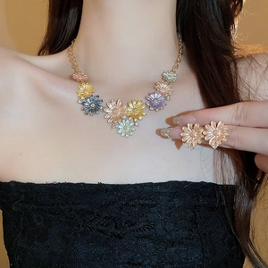Vintage floral jewelry set with colorful enamel petals and tiny crystals on gold chain