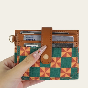 Brown leather RFID card holder with geometric windmill pattern and secure snap closure