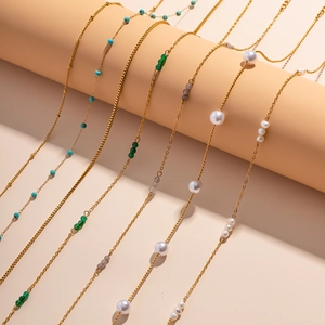 Detail view of 18K gold plated stainless steel necklaces with pearls and turquoise beads