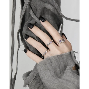 S925 sterling silver chain ring set with colorful zircon stones on grey linen texture