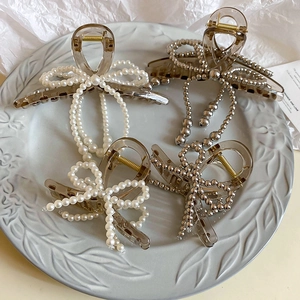 Acrylic hair claw clips with faux pearl and silver bead bow designs in brown finish