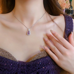 Close-up of a zircon purple gourd pendant necklace on a model's neck for elegant women