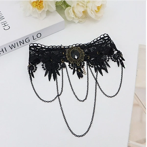 Detailed view of Gothic black lace choker featuring vintage centerpiece and metal chains
