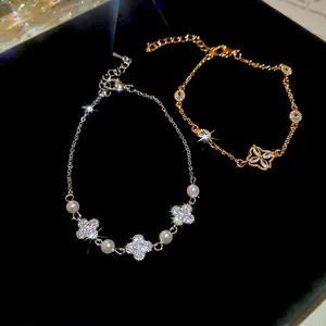 Elegant French vintage bracelets with pearls and zircon flower charms on black velvet