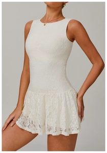 Detailed close-up of white lace fabric with rose floral texture on sleeveless dress