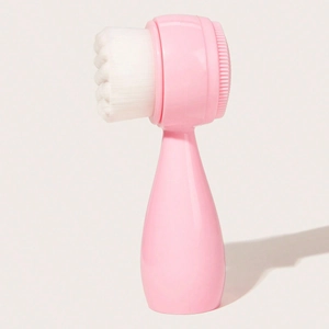 Close-up of pink dual-sided facial brush with soft white bristles and massage silicone pad