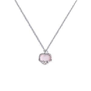 Pink heart crystal necklace with silver bow pendant and zircon details on white backdrop