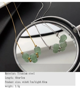 Detail of titanium steel necklace with green beads and adjustable extension chain