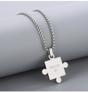 Detail of silver stainless steel puzzle pendant necklace with Weirdo #1 engraving