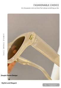 Detail of cream oversized cat-eye sunglasses with golden metal trim on temples