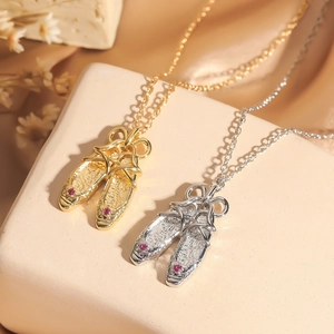 Elegant gold and silver ballet shoe necklaces with sparkling rhinestone accents