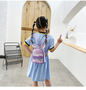 Detail of purple bunny ears backpack with colorful sequins and decorative pearl chain