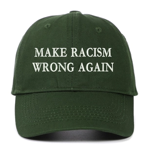 Detailed close-up of white embroidery on a dark green washed cotton baseball cap