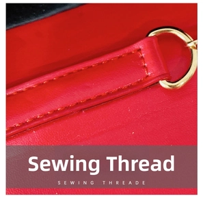 Close-up of red leather girl handbag showing fine stitching and gold metal D-ring buckle