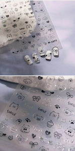 Close-up of M-1077 cute cartoon line art nail stickers featuring puppy and cat designs