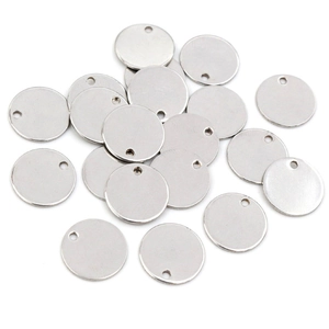 Macro detail of round stainless steel blank pendants for DIY jewelry making