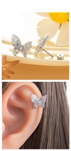 Close-up of butterfly stud earring with sparkling crystals and screw back on display