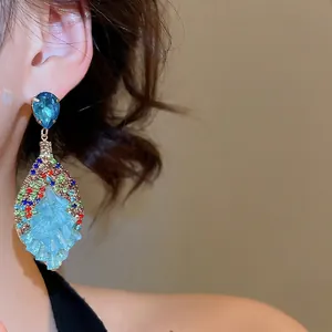 Luxurious bohemian drop earrings with multi-colored crystals and blue resin accents