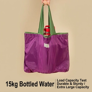 Eco-friendly foldable large shopping bag in purple with green handles and heavy load capacity