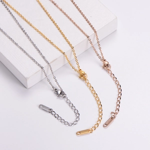 Close-up of titanium steel necklace chains in silver, gold, and rose gold with lobster clasps