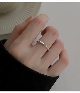 Macro view of geometric square-cut silver ring with reflective faceted textures