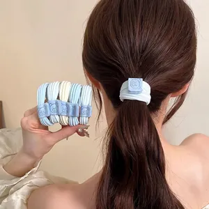 Sweet blue and white fabric scrunchies featuring a cute bear charm for elegant ponytails