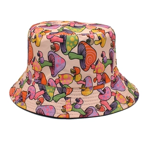 Close-up of vibrant mushroom prints on a beige sun hat with detailed textile texture