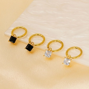Square colored zircon drop earrings in gold titanium steel on luxury marble background