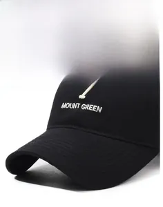 Detail of white 3D embroidery showing 7 MOUNT GREEN on a black cotton baseball cap
